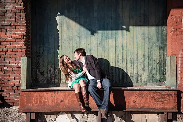 laughing happy couple sitting on dock