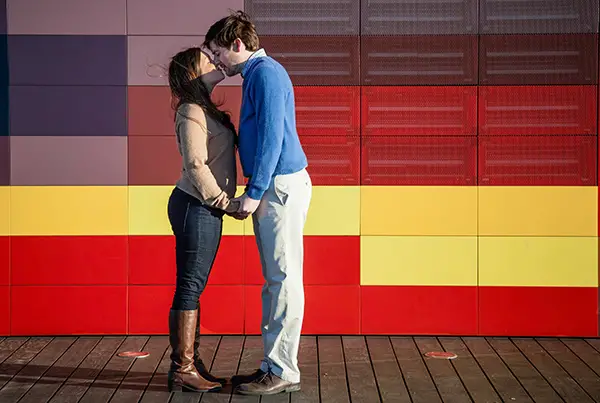 couple kissing in front of colorful Beale Street Landing in Memphis