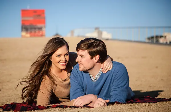 couple laying on the hill by Beale Street Landing in Memphis