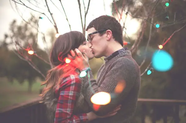 christmas card engagement photo ideas wrapped in lights