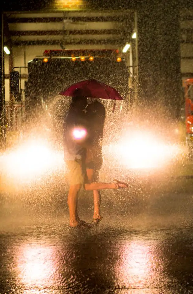 Christine & Zac's Fire Station Engagement Session photos in the rain in front of fire truck - photo by Crystal Brisco Photography  