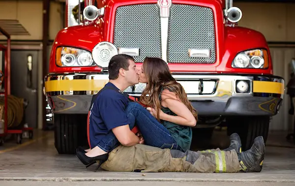 Christine & Zac kissing in front of fire truck for Firefighter Engagement Session - photo by Crystal Brisco Photography - midsouthbride.com 2