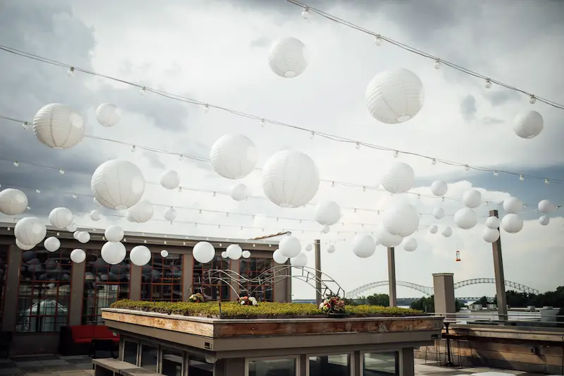 Old Dominick Distillery Memphis Wedding Venue rooftop terrace during the day with lanterns and lights strung up photo by The Warmth Around You 