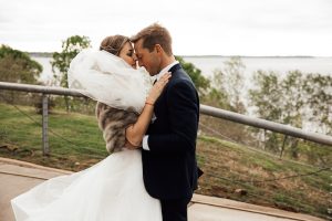 couple embracing in front of the Mississippi River at Metal Museum Memphis wedding photo by The Warmth Around You