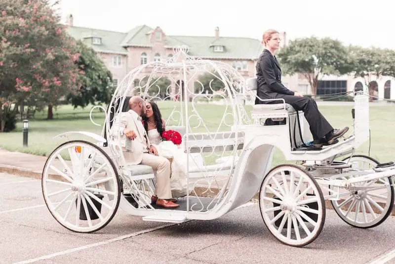 couple in a carriage in front of the fairytale castle Pink Palace Museum